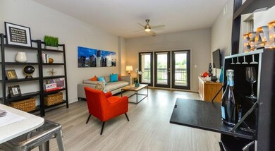 Living room featuring ceiling fan, french doors, a