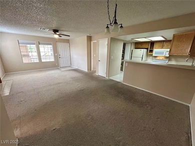Unfurnished living room with a ceiling fan, light