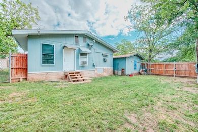 Rear view of property featuring entry steps, a fe