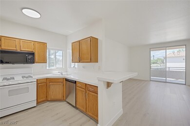 Kitchen with black microwave, white range with gas