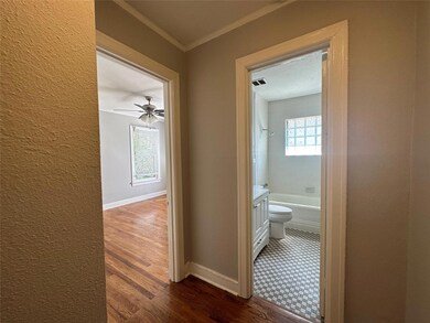 Hallway featuring dark wood finished floors, a tex