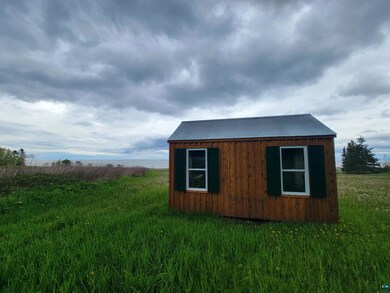View of outdoor structure with a yard