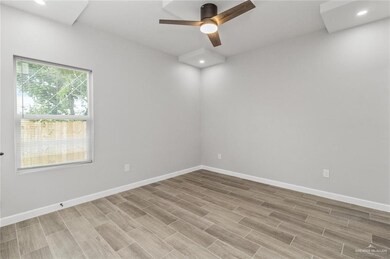 Unfurnished room with a ceiling fan, wood finish floors, and recessed lighting