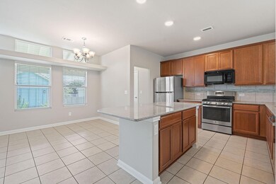 Kitchen with light tile patterned floors, stainle
