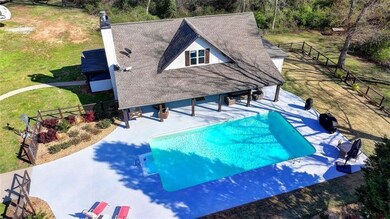 View of swimming pool with a fenced in pool, a pat