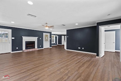 Unfurnished living room featuring a fireplace, vis