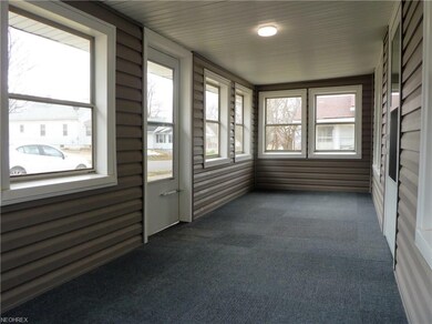 Enclosed front porch/three-season room.