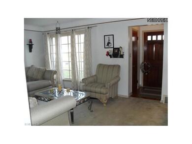 Living Room With Large Front Window Neutral Color 