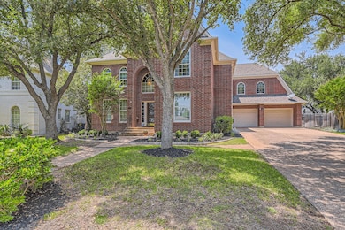 Colonial-style house featuring fence, brick sidin