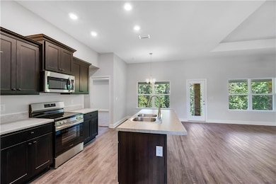 Kitchen featuring pendant lighting, light hardwood