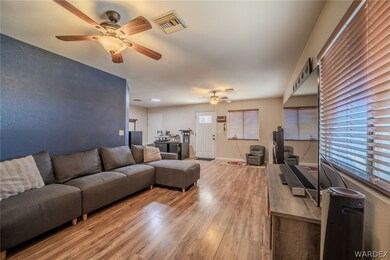 Living room featuring ceiling fan and hardwood / w