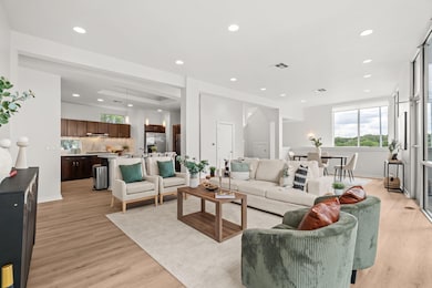 Living area with light wood finished floors, plen