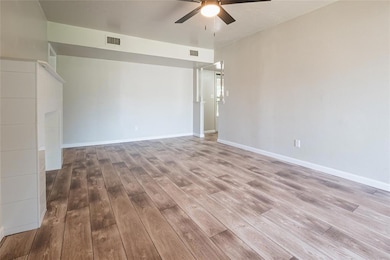 Empty room featuring light wood-style flooring and ceiling fan