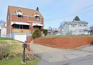 A one-car integral garage and long driveway offers