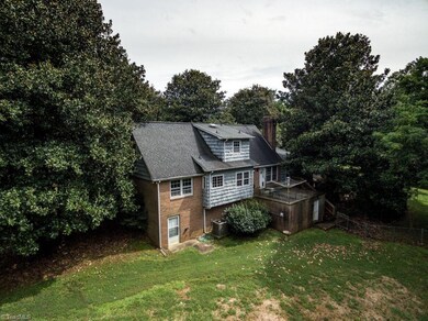 Rear view of the home with private, wooded back yard.