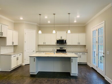 Gourmet kitchen, with large center island, granite included, stainless steel appliances with gas cooking option.  LED lights and pendent lights over island. 