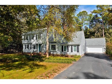The newly paved Driveway leads to the Rear Loading Garage as well as the Detached 2 1/2 car garage with workshop area.