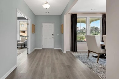 Entryway with wood finished floors and baseboards