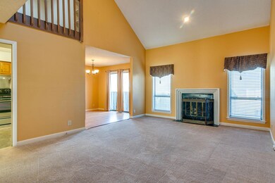 Large Vaulted Living Room with a view of the Dining Room which has hardwood flooring