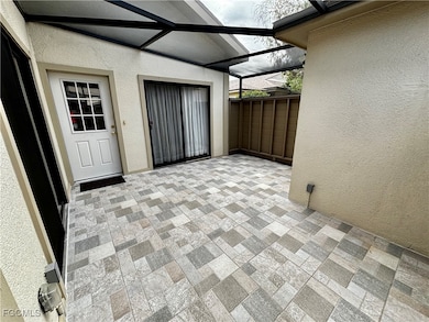 View of patio featuring a sunroom and a lanai
