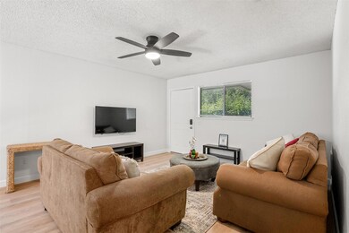 Living area featuring light wood-style floors, ce