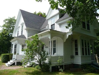 Exterior Side View. Lilac trees and...