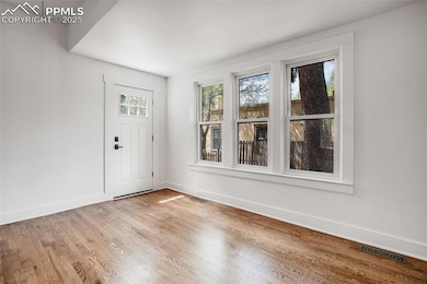 Foyer featuring light wood-style floors, visible v