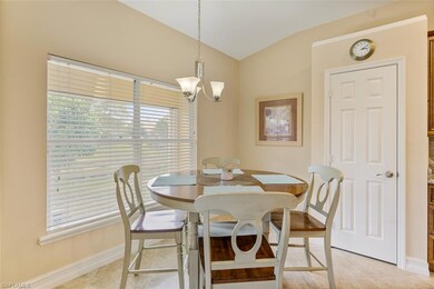 Dining space with light tile patterned floors, bas