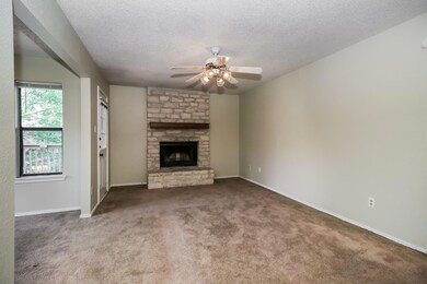 Unfurnished living room with a ceiling fan, a sto