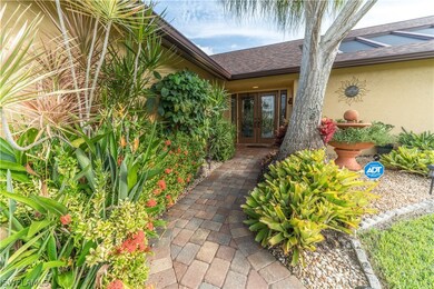 Pavered entry with lush landscaping