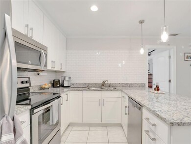 Kitchen with stainless steel appliances, white cab