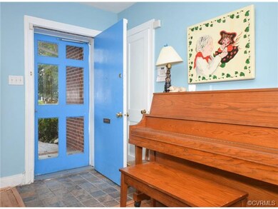 The front door is welcoming with a wooden storm do