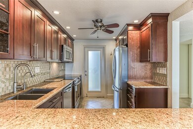 Kitchen offers wood cabinets, granite counters and