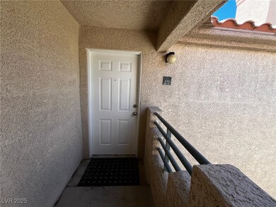 Doorway to property with a balcony and stucco sidi