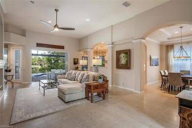 Living room with arched walkways, ceiling fan, plenty of natural light, recessed lighting, and crown molding