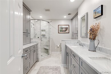 Bathroom with a shower with door, tile patterned f