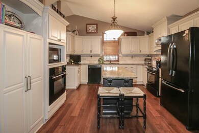 Off white cabinets, black appliances, spice rack, 