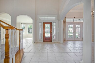 Grand entry boasts tile flooring, 2-story ceiling, curved staircase and both formals.