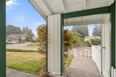 Covered front porch with additional storage on the right.