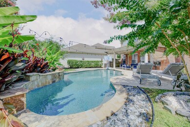This inviting backyard oasis showcases a sparkling