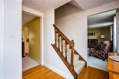 Hardwood floors greet you in the entry of this lov