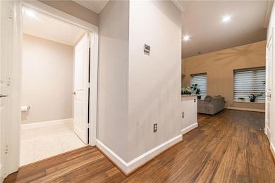 Corridor featuring ornamental molding, baseboards,
