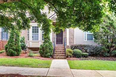 View of front facade featuring brick siding and a front yard