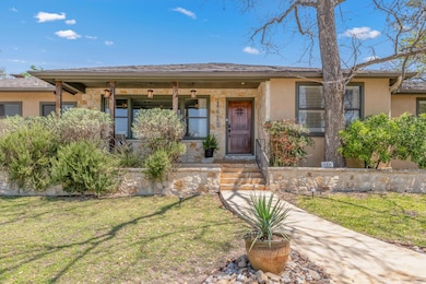 View of front facade with a porch, stucco siding,