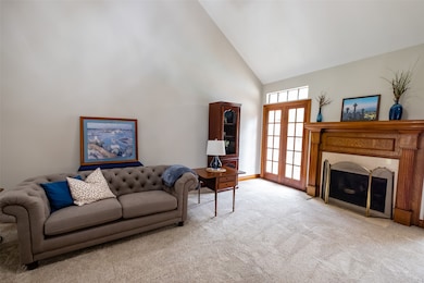 Another view of the living area with French doors leading to the sparkling pool.