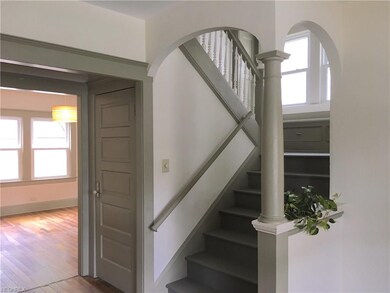 Stairwell looking toward side entry/basement door and dining room.