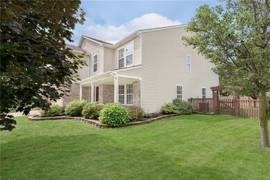 Attractive landscape & arbor gate to fenced backyard.
