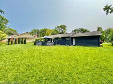 Back of house with a yard