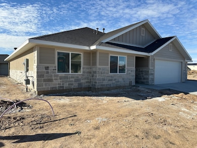 View of front of home with stone siding, board and batten siding, a garage, a shingled roof, and driveway