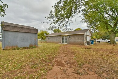 View of yard featuring central AC and a shed